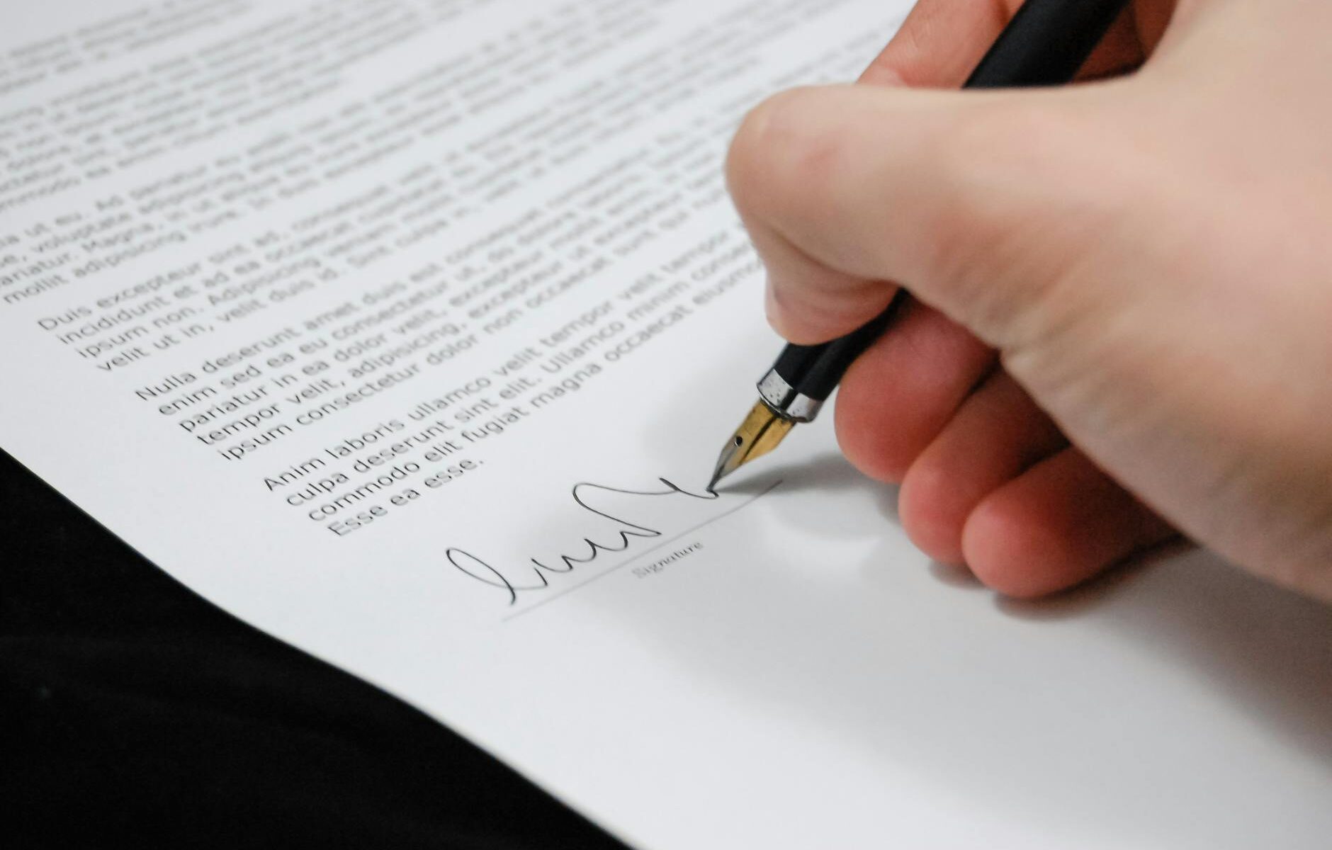 person signing in documentation paper